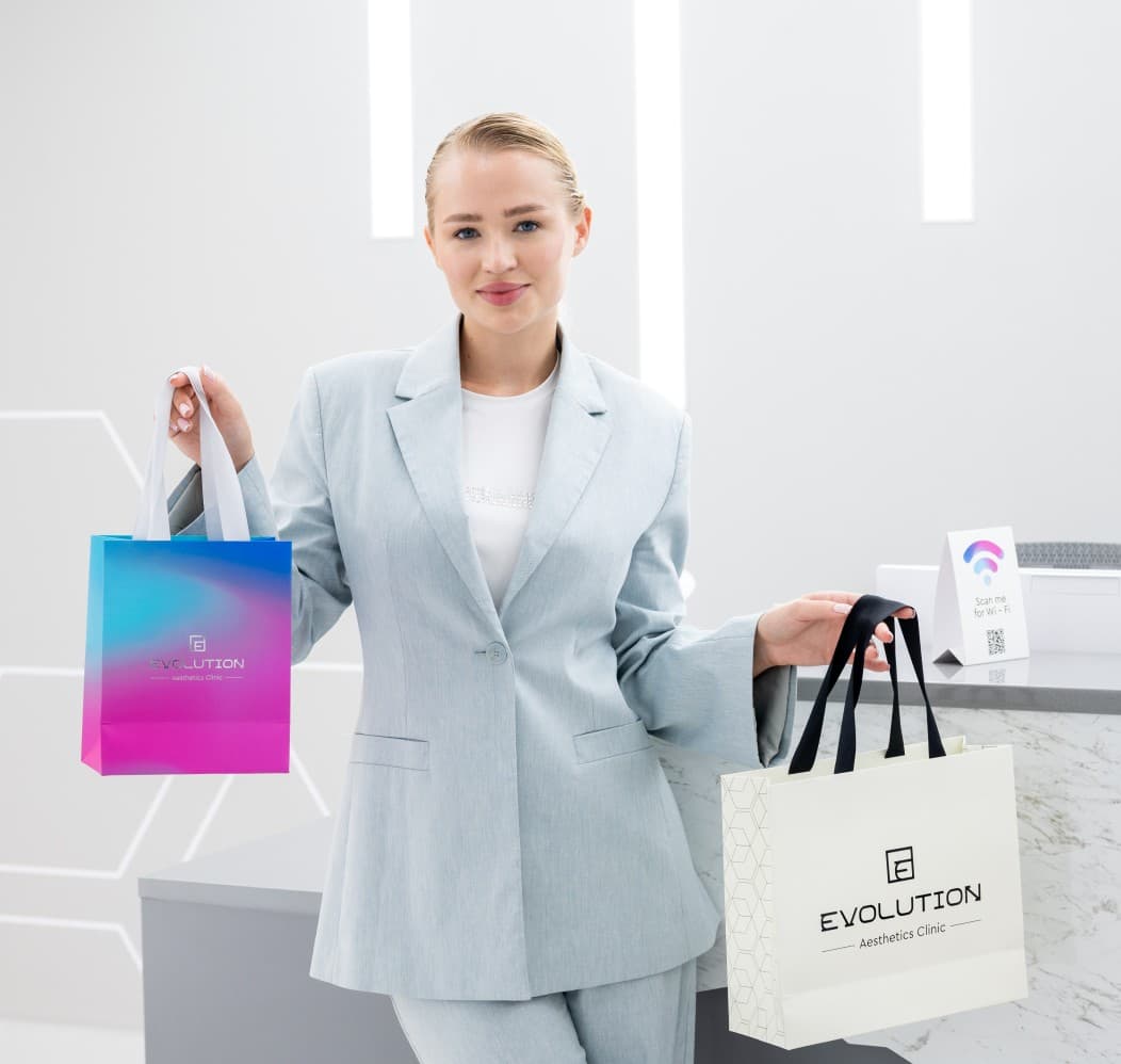 Woman holding Evolution gift bags